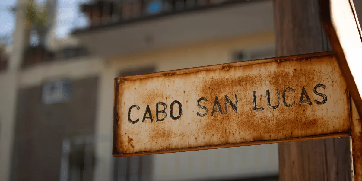 A small, slightly rusted sign that says Cabo San Lucas