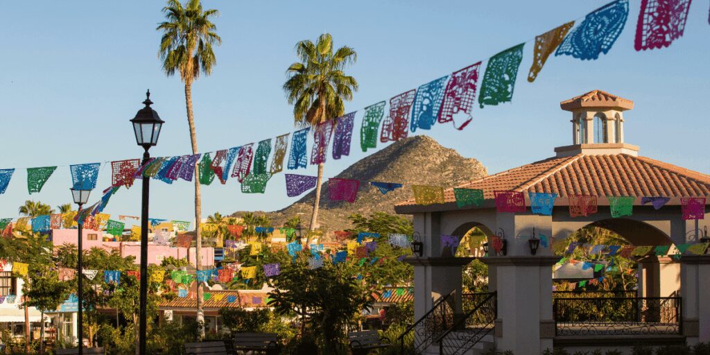 A public plaza in Cabo San Lucas with a mountain in the background