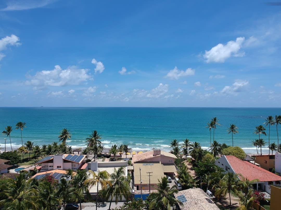 The balcony of a modern, luxurious villa with comfortable seating, offering a breathtaking view of the turquoise ocean, embodying the dream Cabo lifestyle.