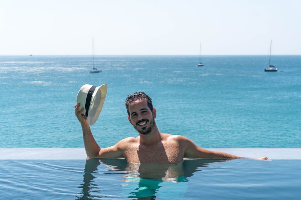 Modern luxury villa with a sparkling infinity pool overlooking the ocean in Cabo San Lucas, representing a dream real esta...