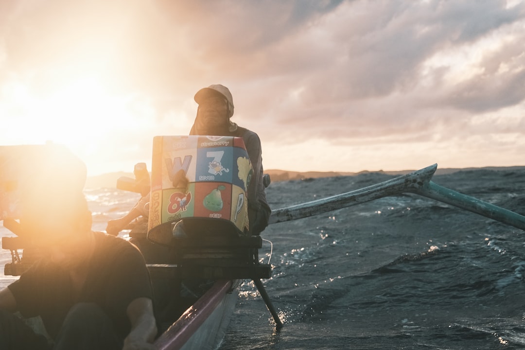 A woman sits at a beautiful table on a sunny terrace overlooking the ocean in Cabo, calmly organizing paperwork, connecting the administrative process with the rewarding lifestyle.