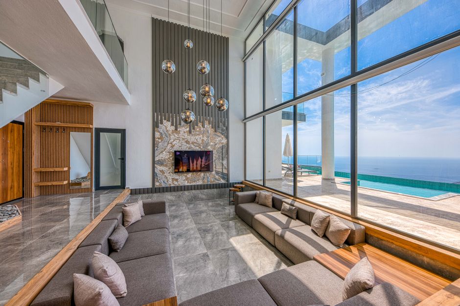 A beautifully furnished modern living room with a comfortable couch, featuring a bright and airy coastal interior design style perfect for a home in Cabo.