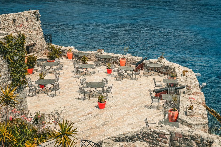 A luxurious outdoor patio with comfortable, stylish furniture overlooking the ocean in Cabo, showcasing the indoor-outdoor living and local furnishing possibilities.